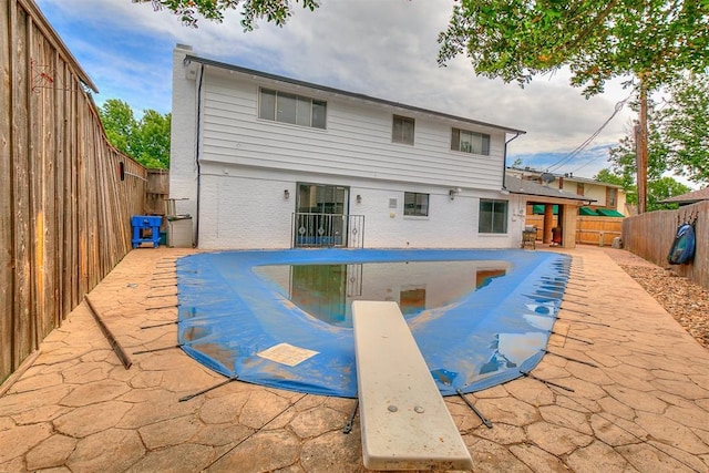7705 Rumsey Rd, Oklahoma City, OK 73132 - view of swimming pool with a diving board, a fenced in pool, a fenced backyard, and a patio area