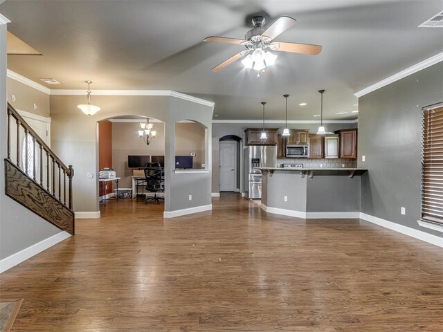 unfurnished living room featuring a ceiling fan, dark wood-style flooring, ornamental molding, baseboards, and arched walkways