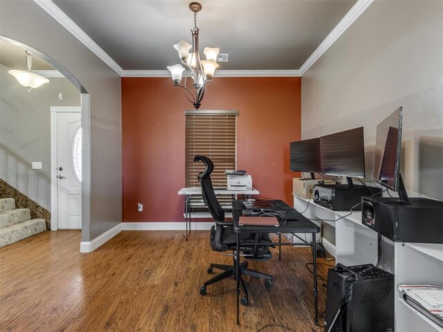 office featuring ornamental molding, wood finished floors, baseboards, arched walkways, and a notable chandelier