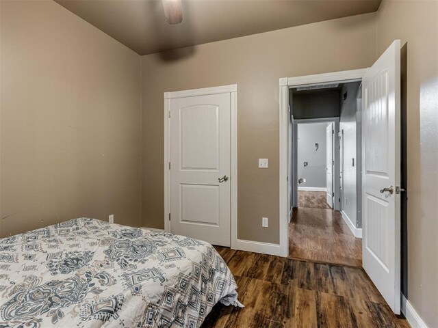 bedroom featuring baseboards, a ceiling fan, and wood finished floors