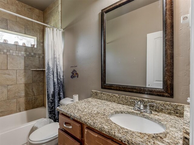 bathroom featuring vanity, shower / bath combo with shower curtain, and toilet
