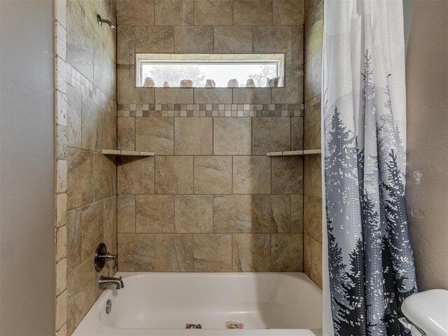 full bathroom featuring a wealth of natural light and shower / tub combo