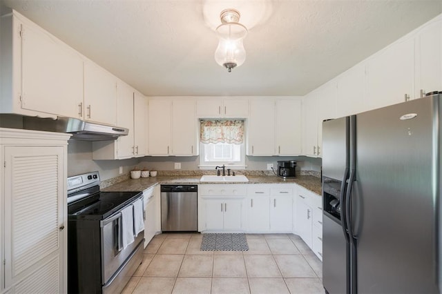 kitchen featuring white cabinetry, stainless steel appliances, under cabinet range hood, and a sink