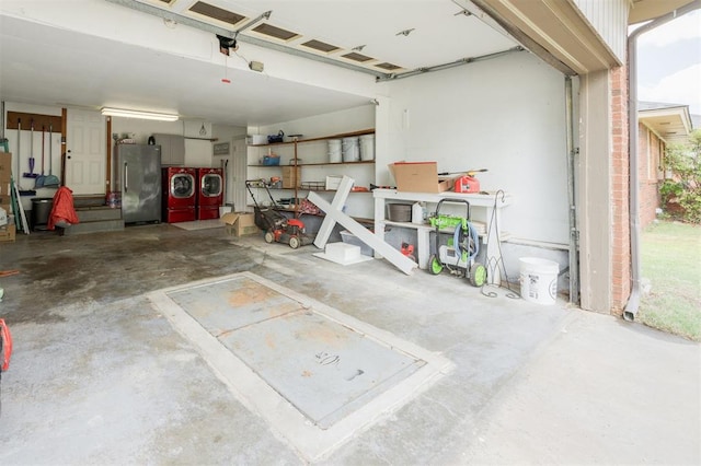 garage with washer and clothes dryer and freestanding refrigerator