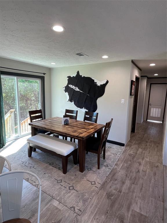 dining space with visible vents, baseboards, recessed lighting, a textured ceiling, and light wood finished floors