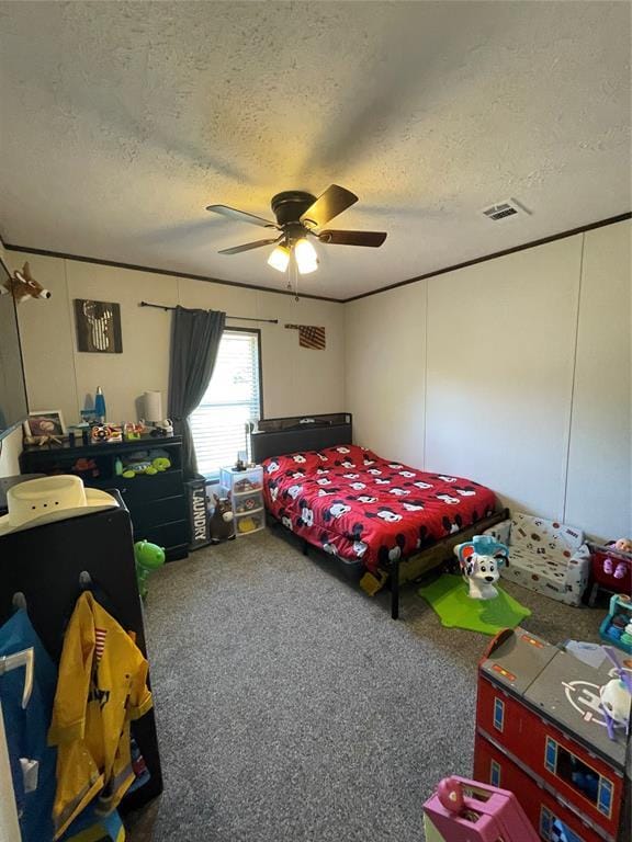 bedroom with ceiling fan, carpet flooring, a textured ceiling, and visible vents