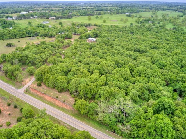 birds eye view of property with a view of trees