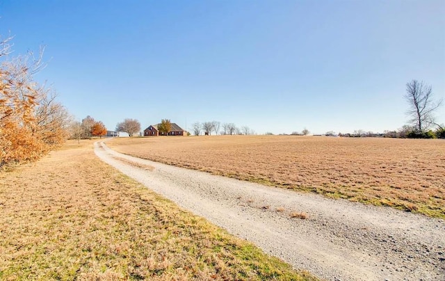 view of road featuring a rural view and driveway