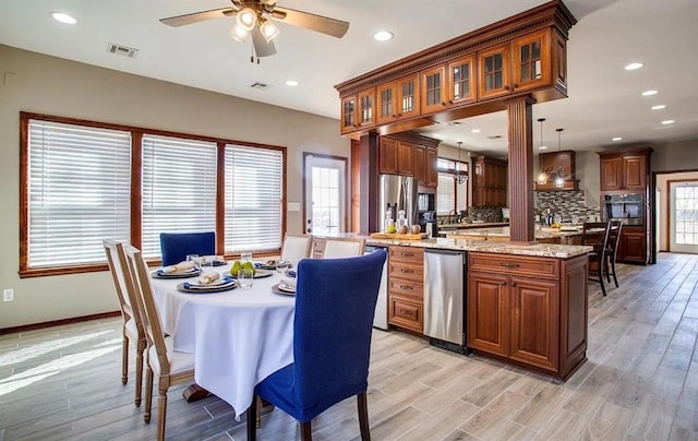 kitchen featuring a ceiling fan, visible vents, light wood-style flooring, and brown cabinetry