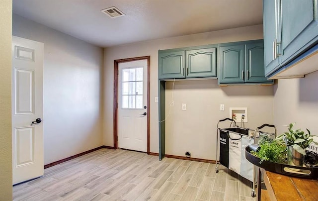 kitchen featuring green cabinetry, visible vents, light wood-style flooring, and baseboards