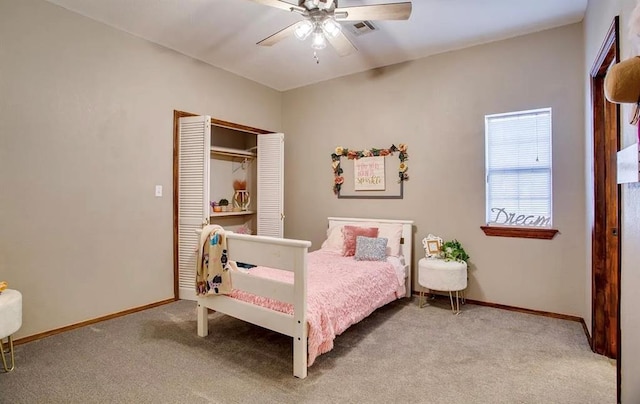 carpeted bedroom featuring baseboards, visible vents, ceiling fan, and a closet