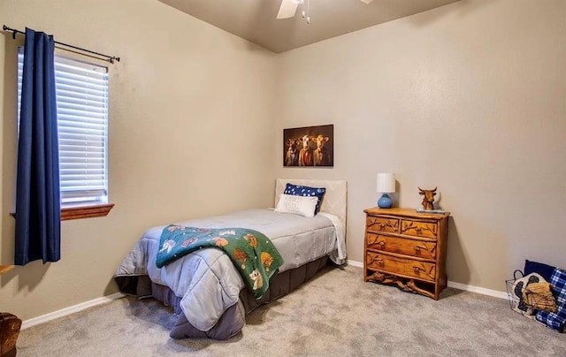 carpeted bedroom featuring a ceiling fan and baseboards