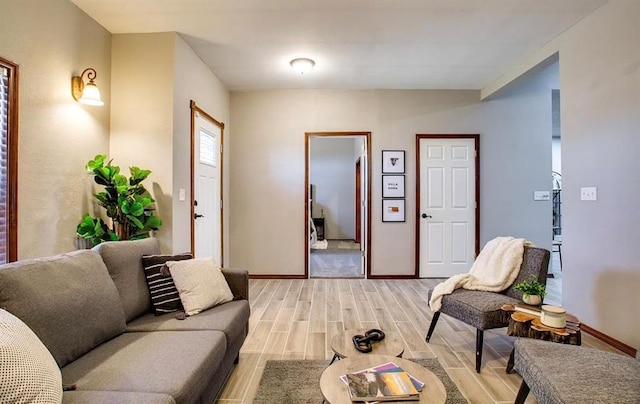 living room with light wood finished floors and baseboards