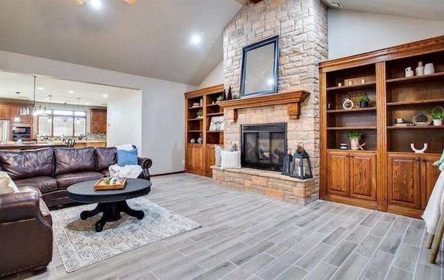 living room featuring a fireplace, light wood finished floors, vaulted ceiling, and baseboards