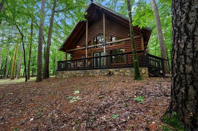 view of side of home with a wooden deck