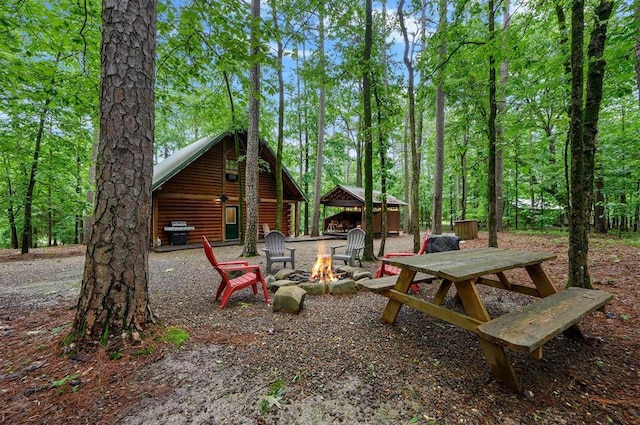 view of yard with an outdoor fire pit