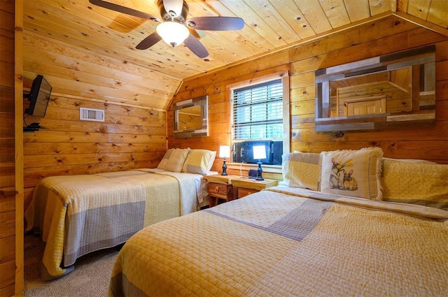 carpeted bedroom with vaulted ceiling, wooden ceiling, wood walls, and ceiling fan