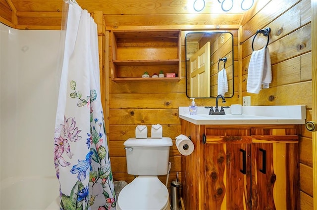 bathroom featuring wooden walls, toilet, and vanity