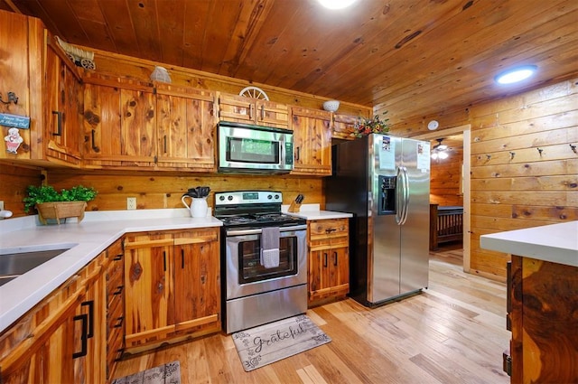 kitchen with appliances with stainless steel finishes, wooden ceiling, wooden walls, light wood finished floors, and brown cabinetry