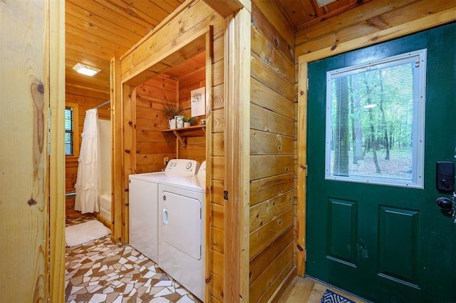 laundry room featuring wood walls, independent washer and dryer, and wooden ceiling