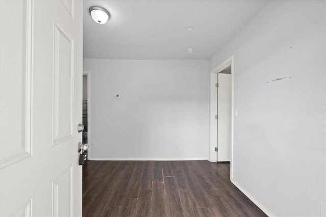 hall featuring wood finished floors and baseboards