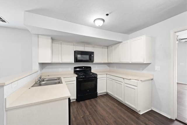 kitchen with dark wood-style floors, white cabinets, black appliances, and a sink