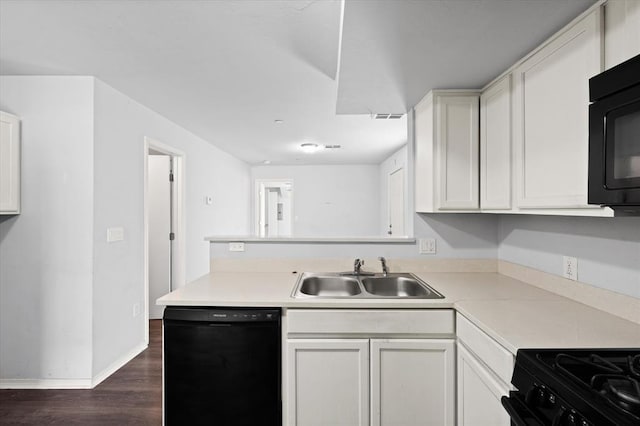 kitchen featuring light countertops, black appliances, a sink, dark wood-style floors, and a peninsula