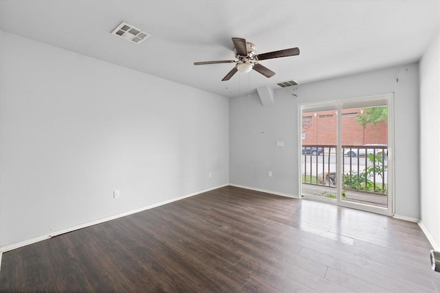 unfurnished room featuring baseboards, visible vents, wood finished floors, and a ceiling fan
