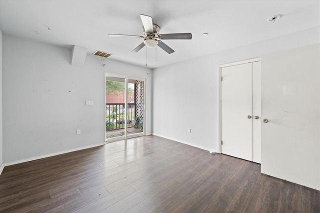 unfurnished room with baseboards, visible vents, ceiling fan, and dark wood-type flooring