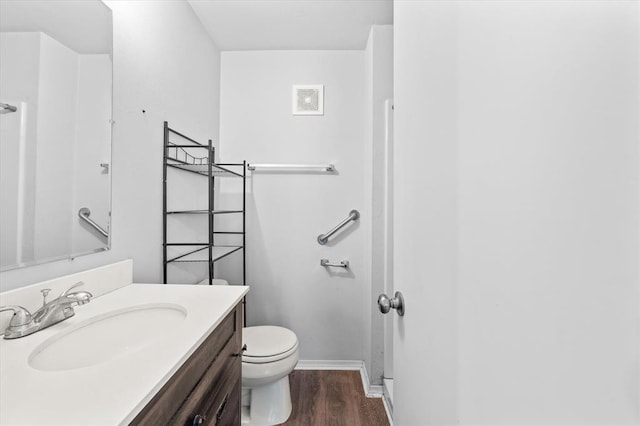 full bath with visible vents, baseboards, toilet, wood finished floors, and vanity