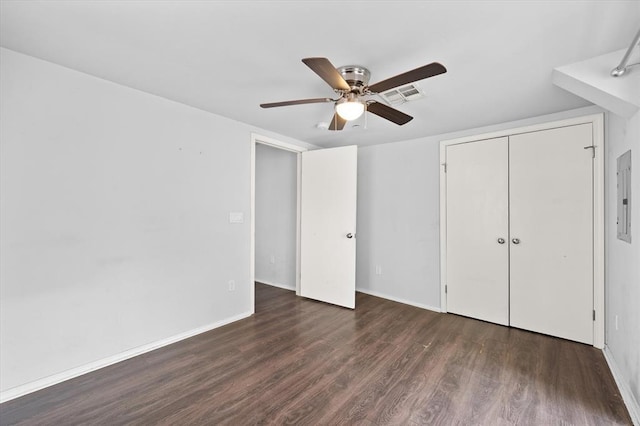 unfurnished bedroom with wood finished floors, a closet, baseboards, visible vents, and a ceiling fan