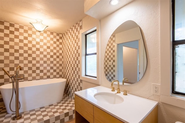 73 E Shore Dr, Arcadia, OK 73007 - full bathroom with a freestanding bath, vanity, and a healthy amount of sunlight
