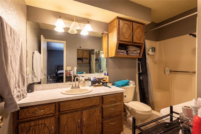 bathroom with toilet, a textured wall, a shower stall, and vanity