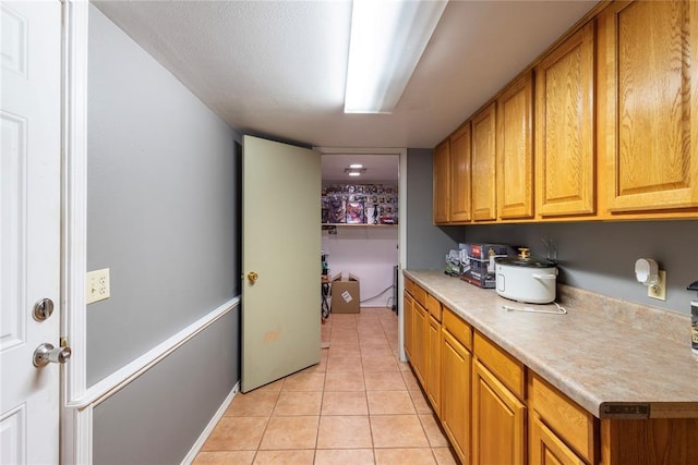 laundry area featuring light tile patterned flooring