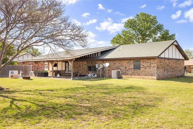 rear view of property featuring a patio area, fence, a yard, central AC unit, and brick siding