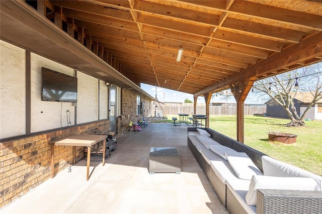 view of patio featuring fence and an outdoor hangout area