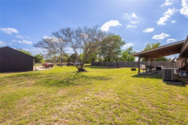 view of yard with fence, cooling unit, and a patio area