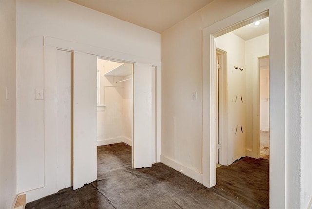 hallway featuring dark carpet