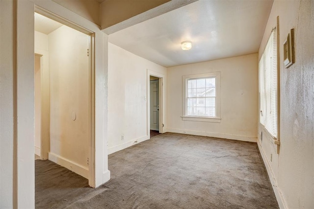 unfurnished bedroom featuring baseboards and carpet