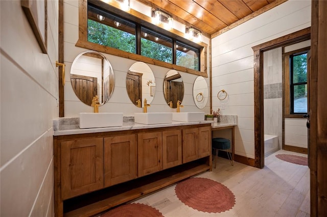 1329 Lake Ridge Ln, Broken Bow, OK 74728 - full bathroom with wood ceiling, wood finished floors, wooden walls, double vanity, and a bath