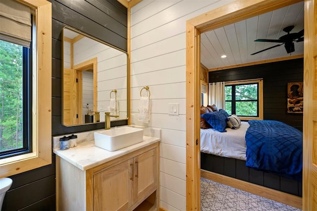 1329 Lake Ridge Ln, Broken Bow, OK 74728 - ensuite bathroom featuring wooden walls, a ceiling fan, and vanity