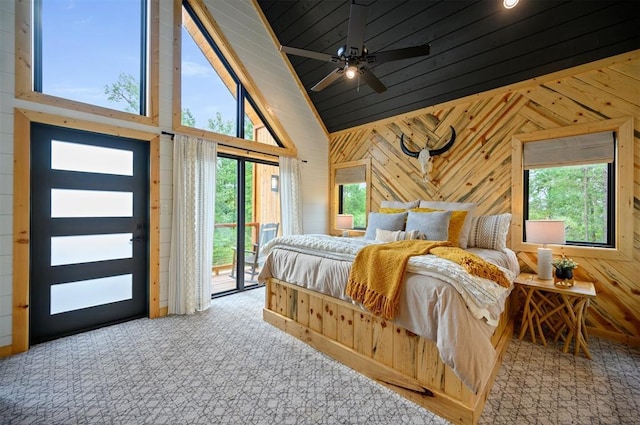 1329 Lake Ridge Ln, Broken Bow, OK 74728 - bedroom with lofted ceiling, access to exterior, wooden walls, and carpet