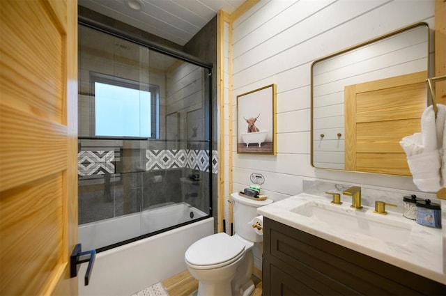 1329 Lake Ridge Ln, Broken Bow, OK 74728 - full bathroom featuring vanity, toilet, enclosed tub / shower combo, and wood walls