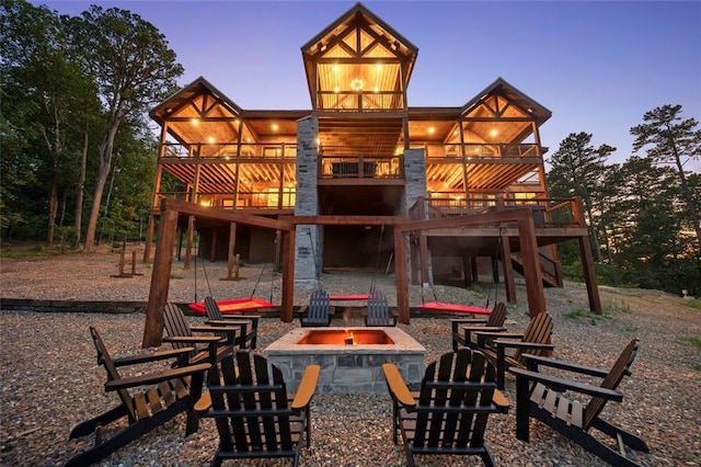 1329 Lake Ridge Ln, Broken Bow, OK 74728 - rear view of property with a fire pit, a deck, stairs, and a patio area