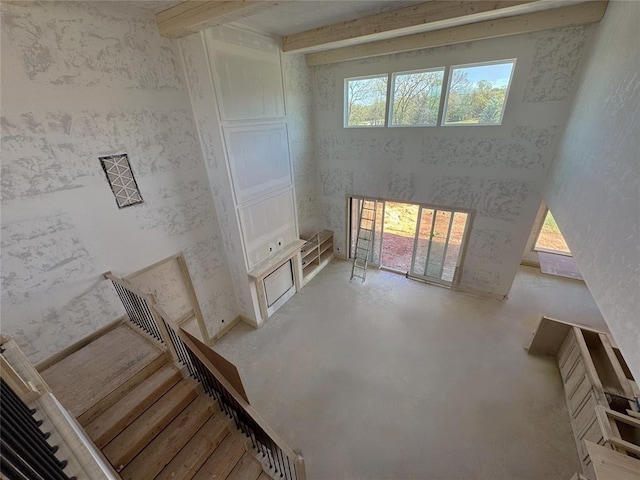 unfurnished living room featuring concrete flooring