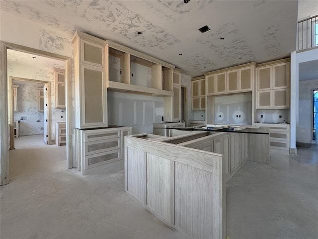 kitchen with glass insert cabinets, a kitchen island, and concrete floors