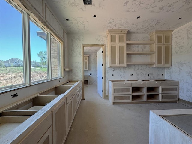 kitchen featuring glass insert cabinets, open shelves, and cream cabinetry