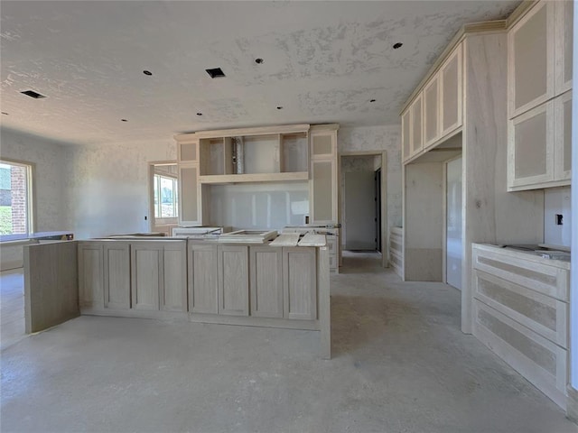 kitchen with a kitchen island, visible vents, and concrete floors