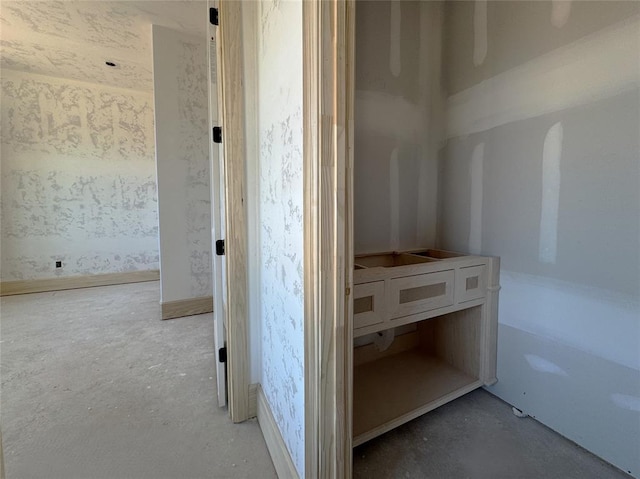 hall with concrete flooring