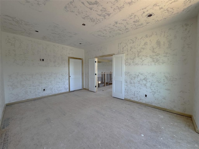 unfurnished room featuring baseboards